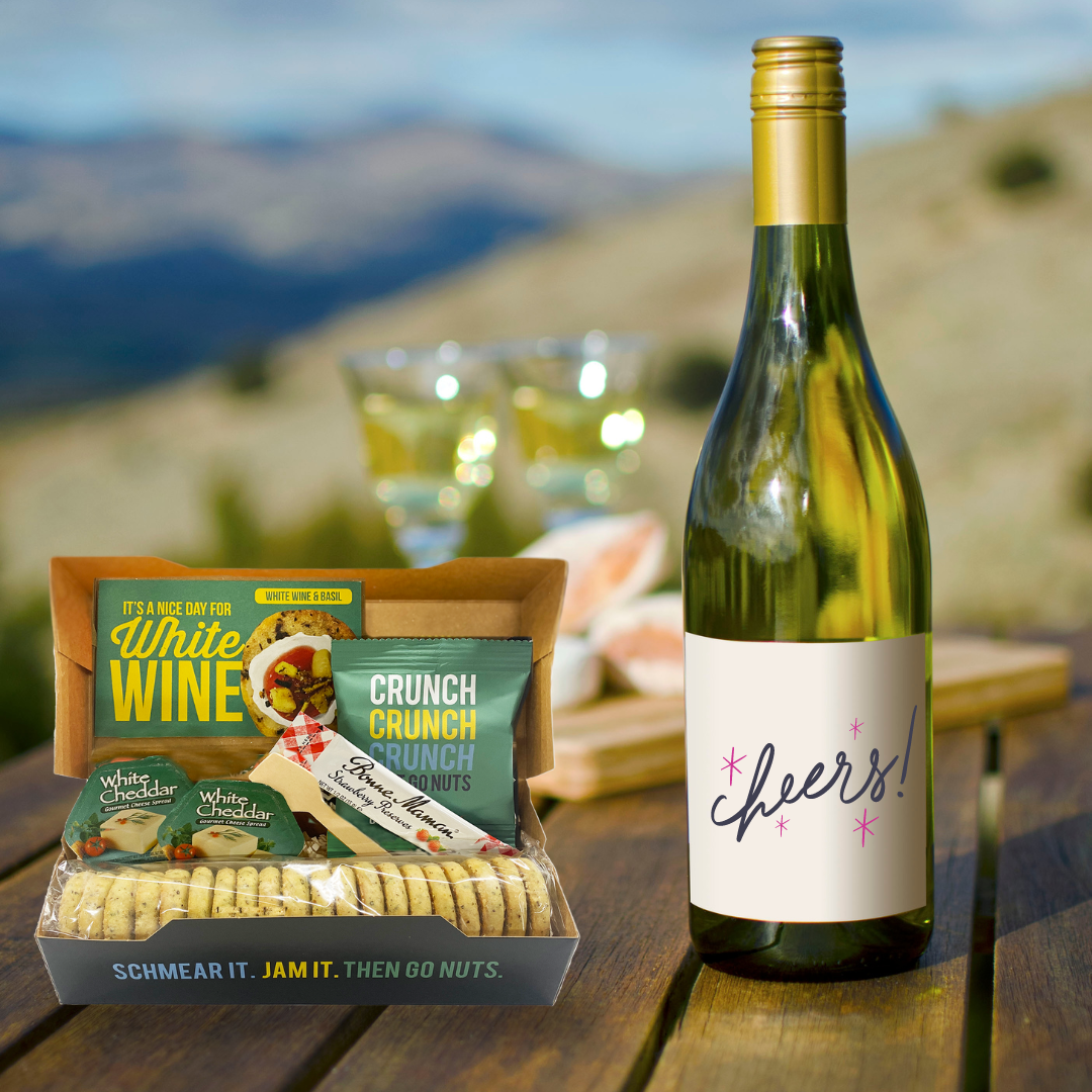 
                  
                    A White Wine  & Basil appetizer kit opened next to a bottle of white wine. 
                  
                