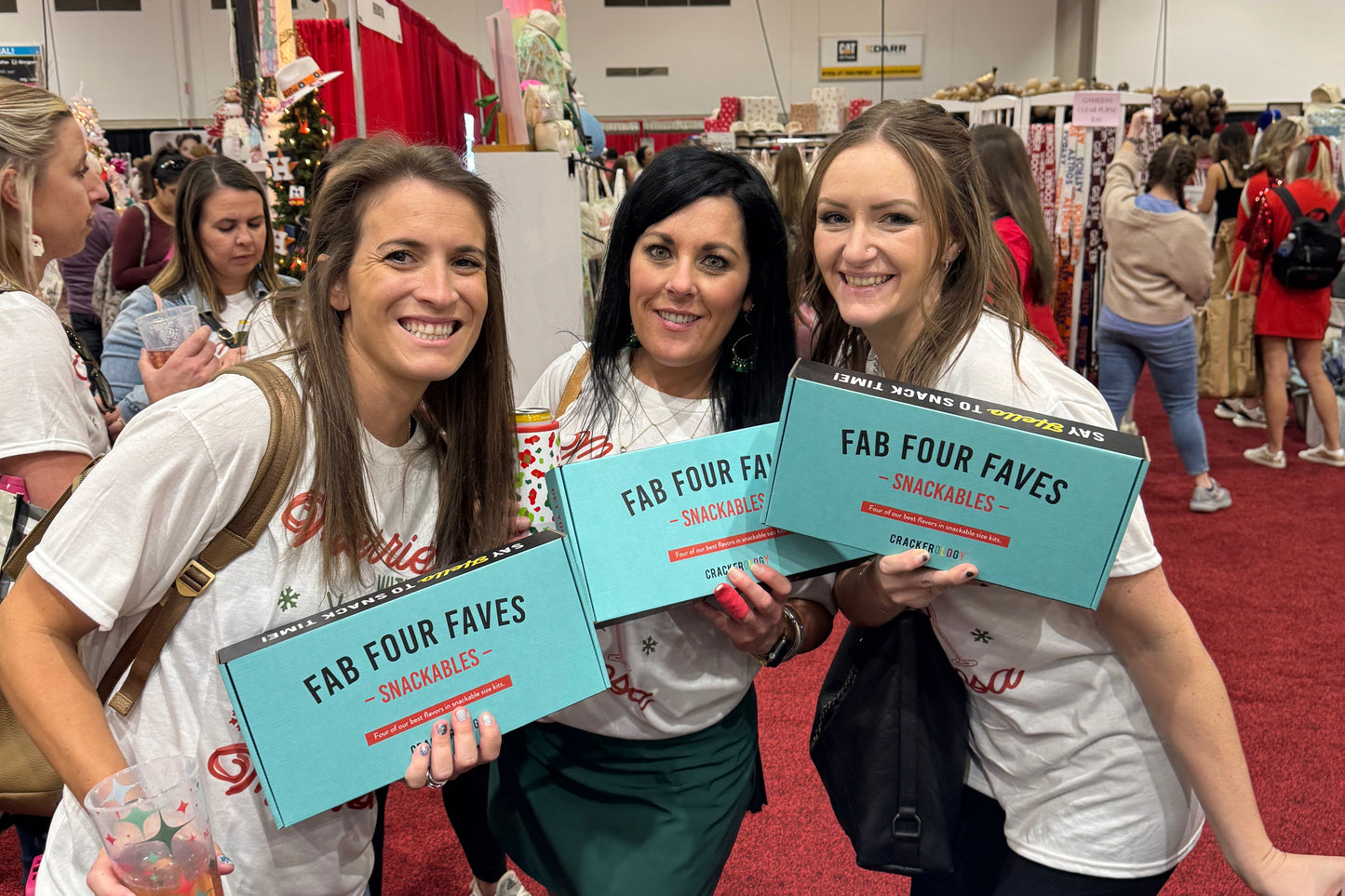 Group of people holding 'Fab Four Faves' boxes in a store setting