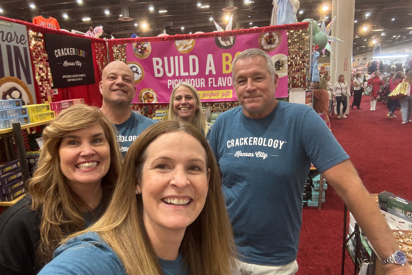Three people in blue shirts from Crackerology.